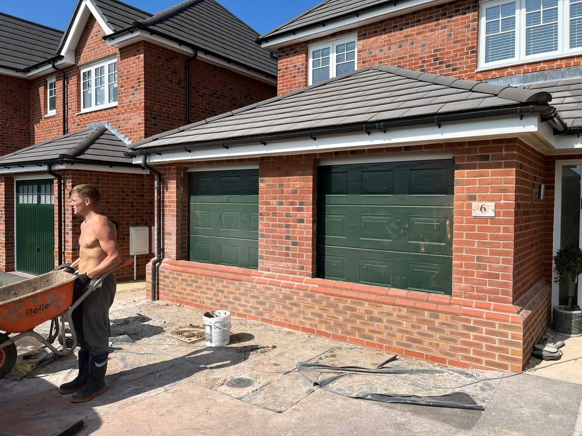 Brick garage frontage prepared for conversion and improvement work
